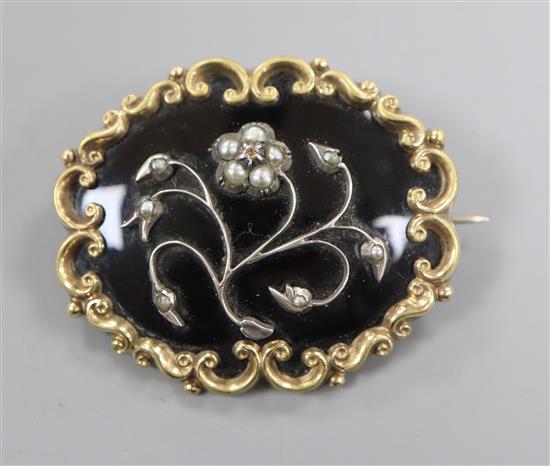 A 19th century pinchbeck , black enamel and seed pearl set mourning brooch, 45mm.